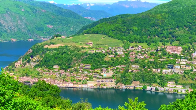 全景式的高山湖卢加诺和村庄Morcote和山在一个阳光明媚的日子视频素材