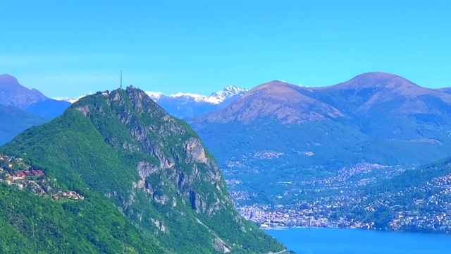 鸟瞰高山湖和城市的卢加诺和山在一个阳光明媚的日子视频素材