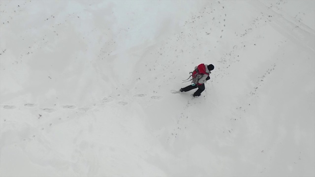 鸟瞰图:人类行走在雪域沙漠视频素材