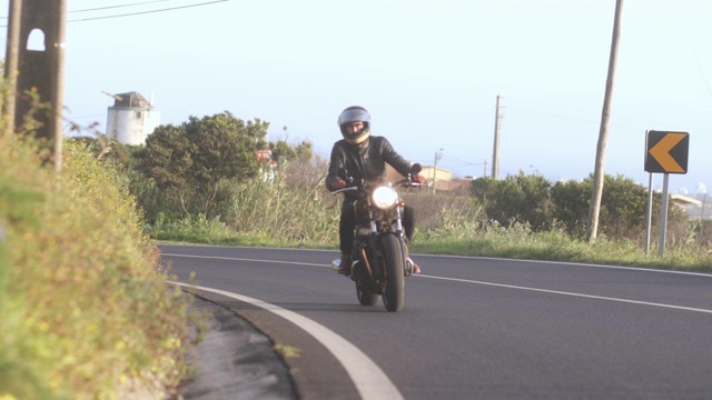 在乡村公路上骑着经典摩托车的人视频素材