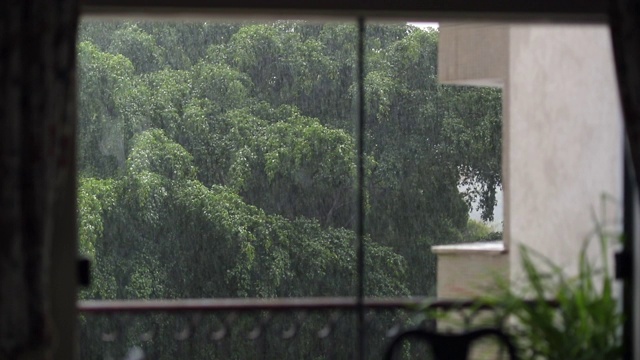 从家里窗户看到的暴风雨天。客厅外面正在下雨视频素材