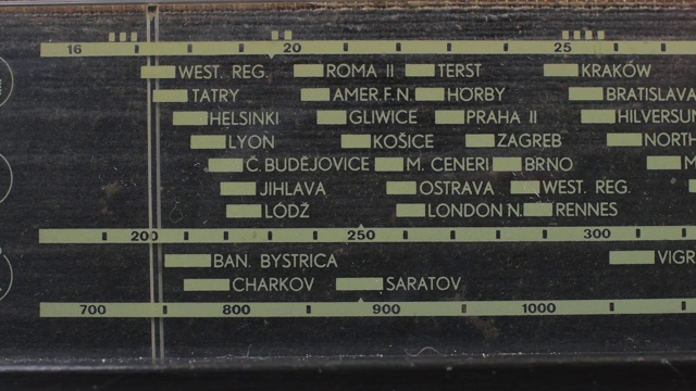 特写的复古收音机与标记运行通过不同的电台和频率。调整模拟无线电拨号频率的规模上的老式接收机。频率标号在长波和中波范围内移动。视频素材