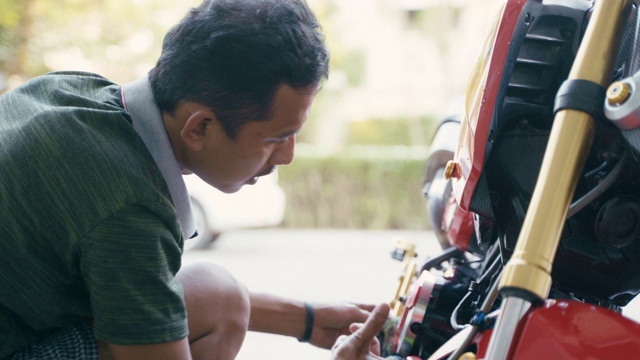 近距离男子在家里用爱心清洗摩托车或自行车，保护自己免受COVID-19冠状病毒感染。视频素材