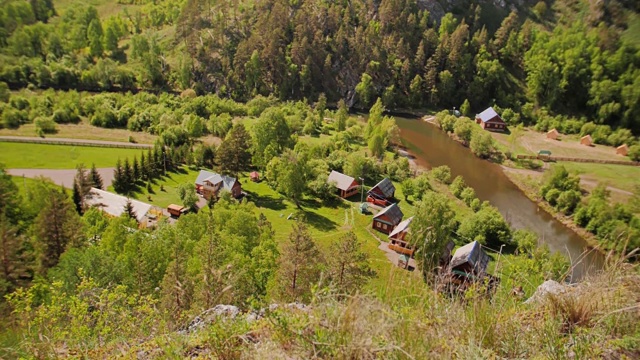 在山脚下的山上有一个小村庄。山区河流视频素材