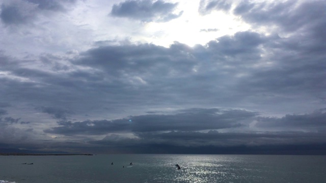 在一个黑暗的暴风雨天，冲浪者在等待海浪视频素材