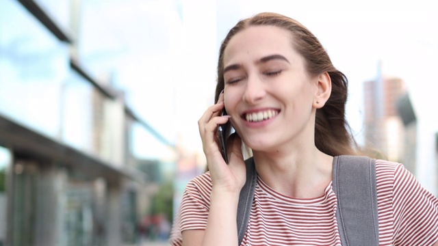 迷人的年轻女子在户外使用智能手机视频素材