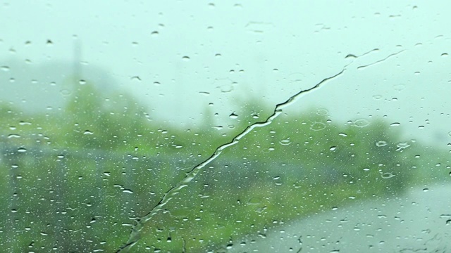 雨打在窗户上，在雨天开车视频素材