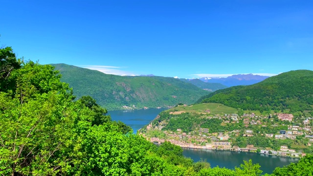 全景式的高山湖卢加诺和村庄Morcote和山在一个阳光明媚的日子视频素材