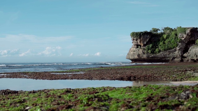 蓝色的海水，裸露的岩石和绿色的珊瑚礁视频素材