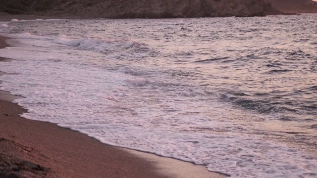 夕阳下海滩上的海潮视频素材