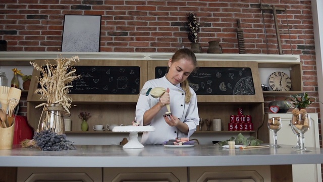 年轻的面包师用糕点袋把奶油涂在杏仁饼干上视频素材