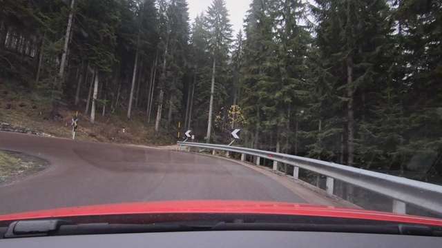 意大利Dolomites，汽车在暴风雨破坏的森林旁边的山路上行驶视频素材