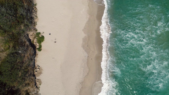 空中俯瞰海景。海浪拍打着沙滩上的沙子。视频素材