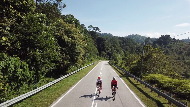 在乌鲁兰加农村地区骑自行车公路旅行与2名女运动员在早上无人机的观点视频素材