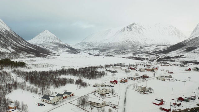 挪威Senja岛Flakstadvag附近积雪覆盖的山脉的航拍图。视频下载