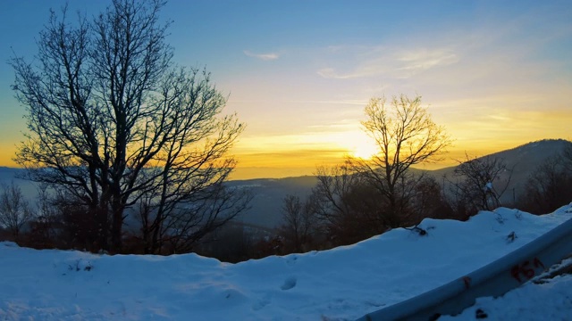 在高海拔的雪山路上行驶，夕阳下的美景令人惊叹视频素材