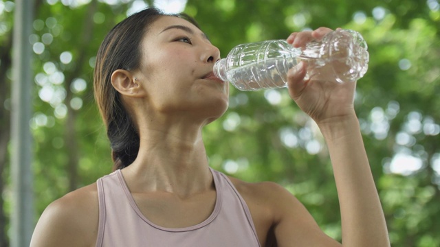 年轻女性锻炼后喝水视频素材