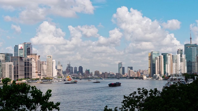 时间流逝4k镜头美丽的上海浦东陆家嘴城市景观，以白云蓝天为背景，货船在黄浦江上航行，b卷拍摄。视频素材