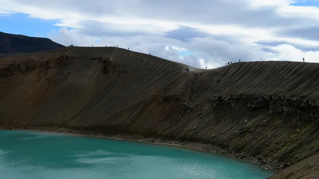 人们走在火山口湖的火山口边缘，Viti火山口，克拉夫拉火山，Myvatn地区，Nordurland Vestra，冰岛北部地区视频素材