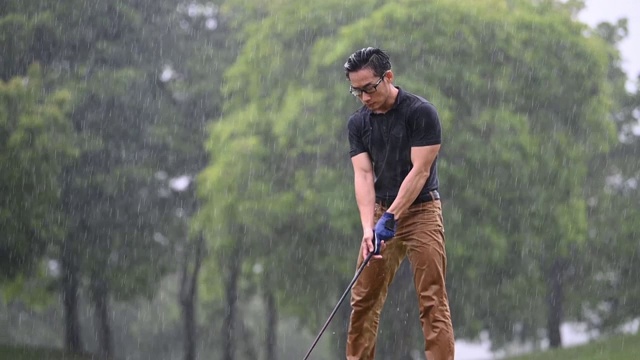 亚洲华人男子高尔夫球打在马六甲独自淋雨视频素材