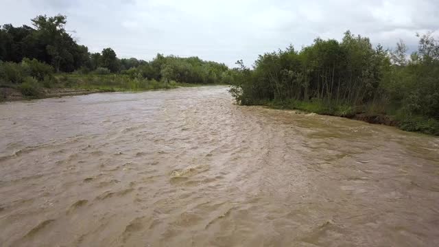 春季暴雨期间，河水泛滥，河水又宽又脏。视频素材