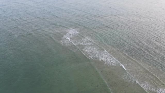 4k空中俯视图放大冲浪者的海滩波，俯视图海浪视频素材