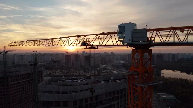 夕阳西下的起重机工地。建造一幢公寓楼视频素材