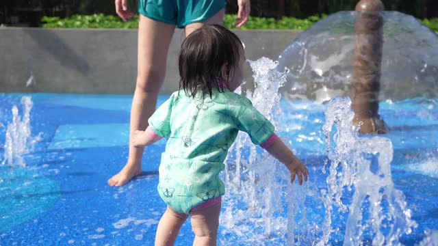 女人和孩子玩溅水视频素材