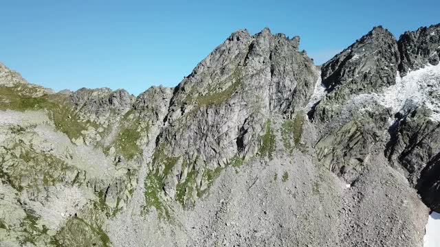 在奥地利Hohe Tauern地区的全景无人机拍摄的斜坡。山坡部分被雪覆盖着。上部陡峭而尖锐。阿尔卑斯山的早春。平静和冷静视频素材