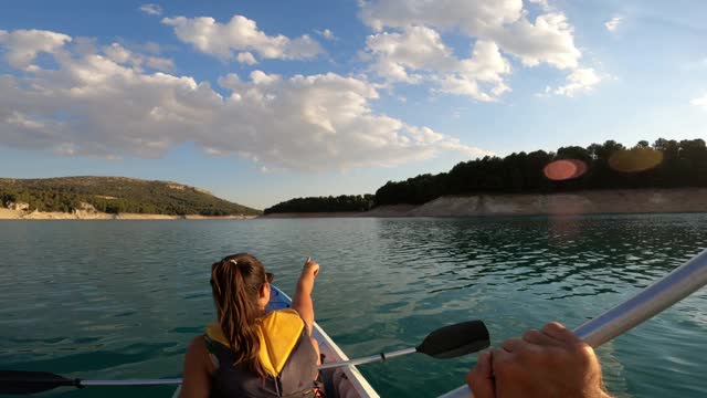 在湖里划船的皮划艇。波夫女士皮划艇在美丽的风景在Embalse de la Bolera，西班牙。视频素材