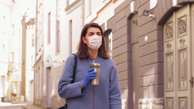 戴着医用口罩，背着平底鞋走在城市里的女人视频素材