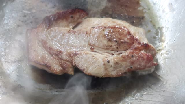 4K，热锅上烤猪肉，翻过来煮视频素材