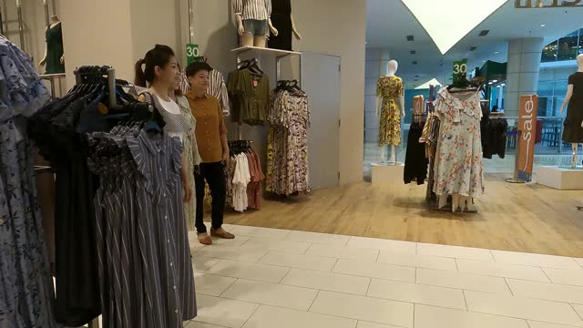 3名亚裔华人女性在服装店选购衣服视频素材