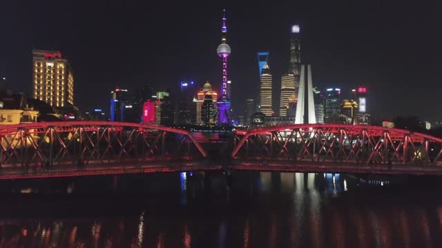 照亮上海市中心的夜晚。陆家嘴区和黄浦江。中国鸟瞰图。无人机正在向上飞行。远景视频素材