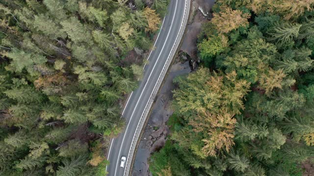 鸟瞰图的汽车行驶在乡村道路，山脉森林。视频素材