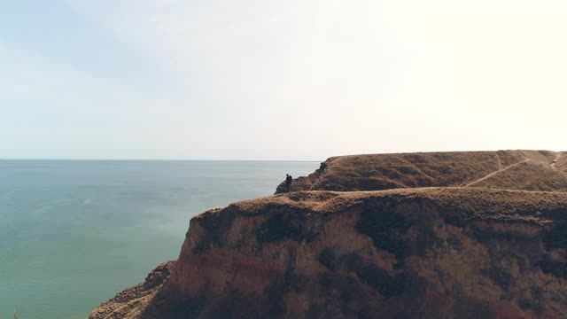 旅行者站在山顶，欣赏美丽的海景视频素材