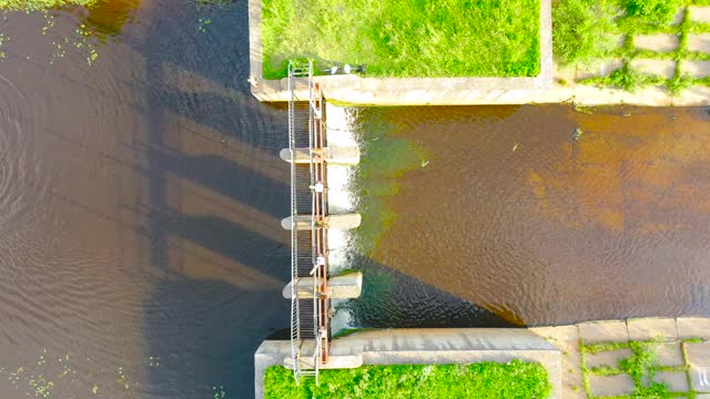 从高处鸟瞰拦河坝，人们在水中游泳视频素材