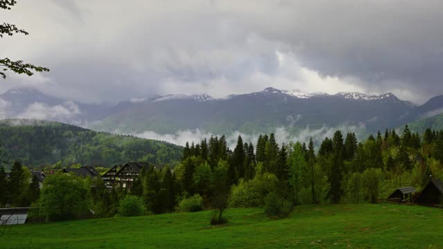 在云雾中有房屋和树木的阿尔卑斯山景观视频素材