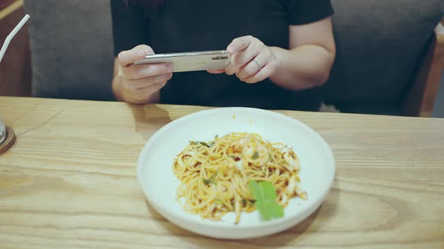 在餐厅用智能手机拉近女人的手视频素材