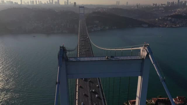 空中的Hyperlapse of Empty Nautical Vessel Ship Crossing Under a Bridge on Bosphorus - Drone Shots of Fatih Sultan Mehmet Bridge on Istanbul Bosphorus at Sunrise stock video伊斯坦布尔，伊斯坦布尔省，马尔马拉，土耳其-中东，Fatih Sultan Mehmet B视频素材