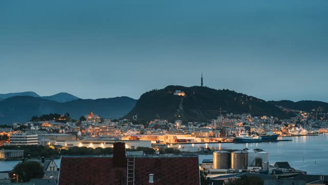 奥勒松,挪威。奥勒松天际线城市景观和港口码头在晚上的夜晚照明。夏天的历史中心。著名的挪威地标和受欢迎的目的地。老奥勒松视频素材