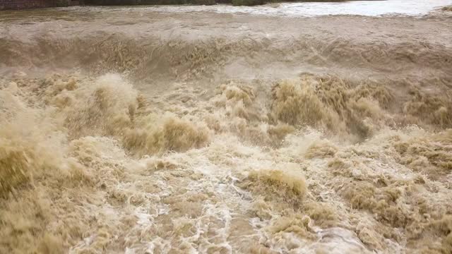 春季暴雨期间河水浑浊的河流鸟瞰图。视频素材