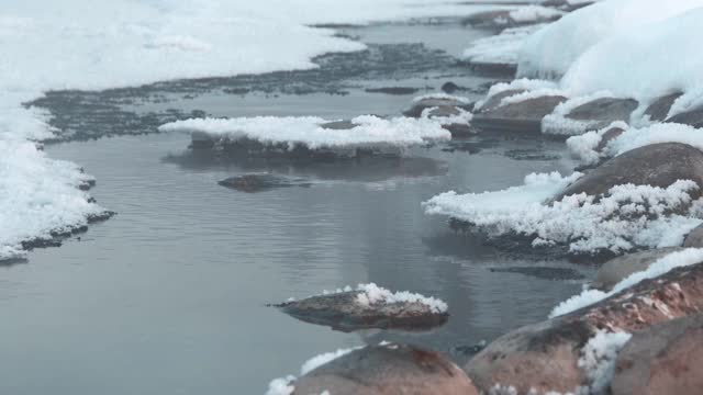 冬天的雪在多雾的河里堆积，晨雾中结着冰视频素材