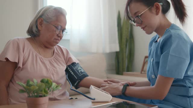 女医生为一位老年病人检查血压。视频素材