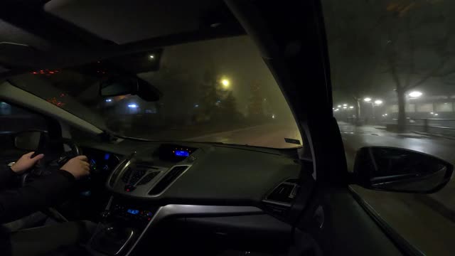 在雨和雾中通过城市的夜间驾驶-视频的4k视频一辆汽车通过城市，用gopro相机从乘客的角度视频素材