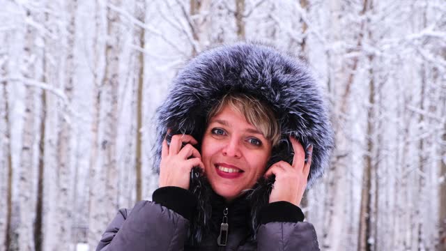 冬天的肖像一个年轻美丽的黑发女人在冬季夹克与毛皮。雪冬美概念视频素材