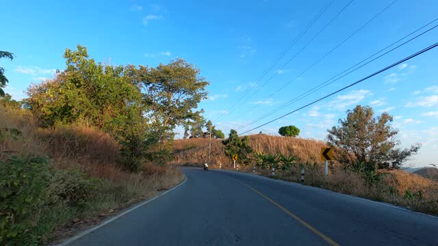 POV驾驶行驶在泰国北部乡村森林中蜿蜒曲折的高速公路上。视频素材