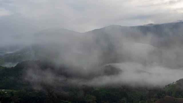 时光流逝的山谷，群山环抱，覆盖着浓厚的地面雾和薄雾高峰，美妙的早晨日出自然景观视频素材