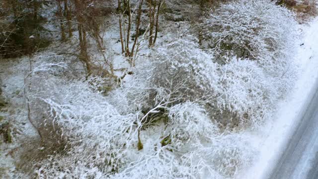 这是一架无人机在苏格兰西南部邓弗里斯和加洛韦的一条被雪覆盖的乡村道路上拍摄的照片视频素材