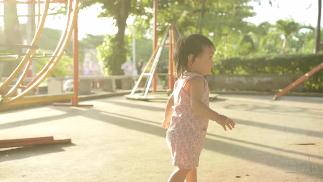 女孩在公园的操场上玩耍。视频素材